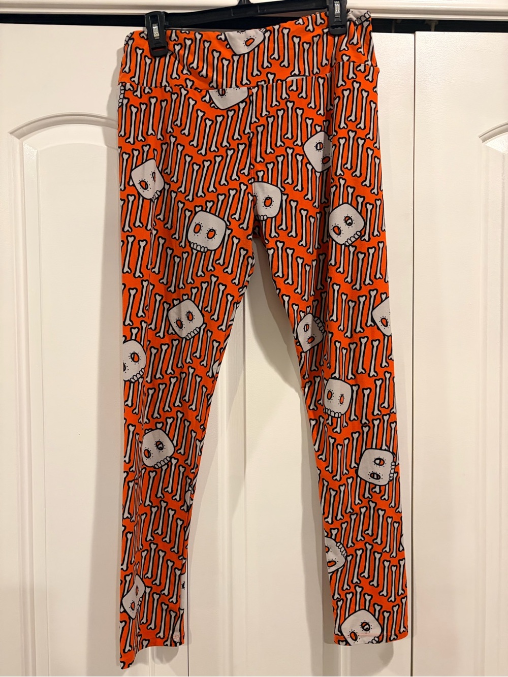 LulaRoe Orange women’s Leggings with Skull & Bone Print